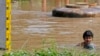A man wades through flooded area in Ayutthaya province, Thailand, Oct. 2, 2013.