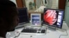 FILE - A doctor checks a screen showing a graphical representation of a human heart.