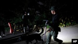 South Korean police officers with dogs leave to search for missing Seoul Mayor Park Won-soon in Seoul, South Korea, July 9, 2020.