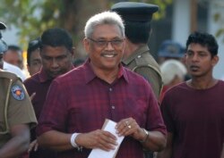 Sri Lanka's former Defense Secretary and presidential candidate Gotabaya Rajapaksa, center, leaves a polling station after casting his vote in Embuldeniya, on the outskirts of Colombo, Sri Lanka, Nov. 16, 2019.