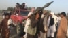 FILE - Taliban fighters gather in Surkhroad district of Nangarhar province, east of Kabul, Afghanistan.