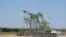 A pump jack stands idle in Dewitt County, Texas, Jan. 13, 2016. Across oil fields from Texas to North Dakota fears are growing that the sharp drop in oil prices could drive many shale producers out of business. 