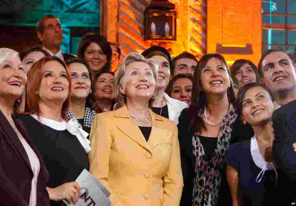 Clinton is accompanied by Turkish talk show hosts during the taping of a show for the Turkish news channel NTV in Ankara, Turkey, March 7, 2009.