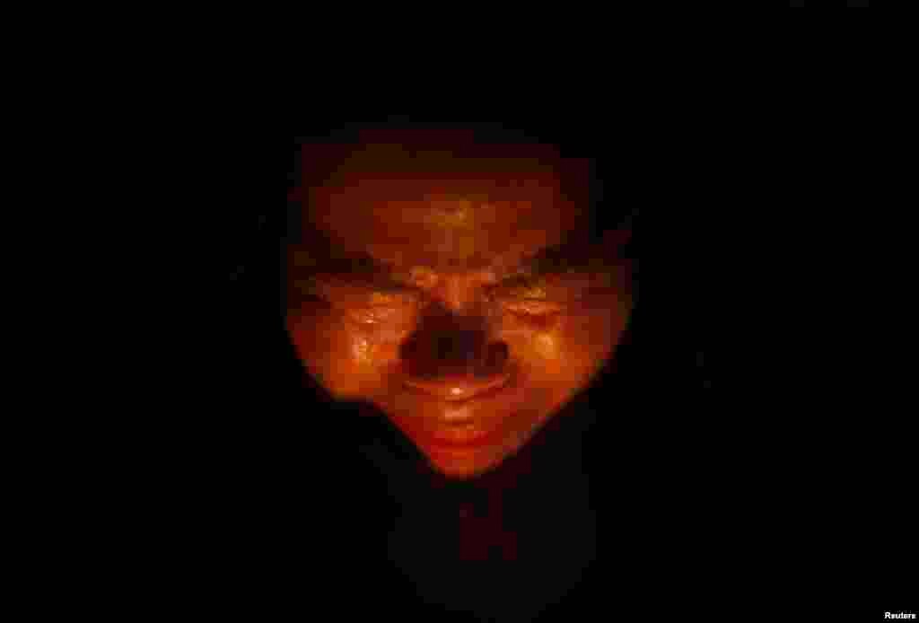 A woman cries while praying during a candlelight vigil in Ansan, to commemorate the victims of capsized passenger ship Sewol and to wish for the safe return of missing passengers.