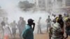 Opposition protesters disperse after tear gas is fired in their midst, in Conakry, Guinea, February 27, 2013 file photo. 