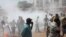 Opposition protesters disperse after tear gas is fired in their midst, in Conakry, Guinea, February 27, 2013 file photo. 