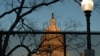 FILE - A security fence topped with concertina wire surrounds the grounds of the U.S. Capitol in Washington, Jan. 19, 2021.