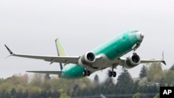 FILE - A Boeing 737 MAX 8 airplane being built for India-based Jet Airways, takes off on a test flight at Boeing Field in Seattle, April 10, 2019. A global team of experts next week will begin reviewing how the Boeing 737 Max's flight control system was approved by the FAA.