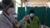 A health worker participates in a COVID-19 vaccine delivery system trial in Hyderabad, India, Jan. 2, 2021.