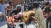 A man, who was injured in a bomb blast, is wheeled on a stretcher to a hospital, in Peshawar, Pakistan, June 8, 2012.