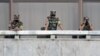 North Korean soldiers keep watch toward the south as South Korean Unification Minister Lee In-young inspects the truce village of Panmunjom, Sep. 16, 2020.
