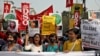 Demonstrators shout slogans during a protest against the arrest of 22-year-old climate activist Disha Ravi, in Kolkata, India, Feb. 23, 2021.