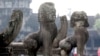 In this photo taken, June 27, 2010, lion statues sit in front of the famed Angkor Wat in Siem Reap province, about 320 kilometers (199 miles) north of Phnom Penh, Cambodia. 