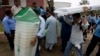 Pakistani election staff carry polling material to stations at a distribution center in Islamabad, Pakistan, July 24, 2018. 