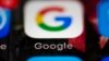FILE- This April 26, 2017, file photo shows a Google icon on a mobile phone in Philadelphia. Google is spearheading an educational campaign to teach pre-teen children how to protect themselves from scams, predators and other trouble. The program announced Tuesday, June 6, is called “Be Internet Aware.” (AP Photo/Matt Rourke, File)