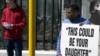 A group of protesters stands outside the South African Parliament on September 21, 2011 in Cape Town, demonstrating against human trafficking and calling for the adoption of the South African Prevention and Combating in Trafficking in Persons (TIP) bill. 