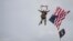 U.S. World War II D-Day veteran Tom Rice, from Coronado, California, parachutes in a tandem jump into a field in Carentan, Normandy, France, June 5, 2019. 