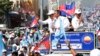 FILE - Cambodia National Rescue Party leaders greet supporters during the last day of campaigning in Phnom Penh, Cambodia. 
