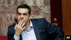 FILE - Greece's Prime Minister Alexis Tsipras gestures during a parliamentary session in Athens, March 30, 2015.