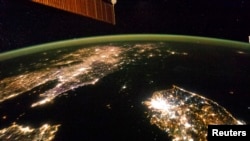 A NASA image released on February 24, 2014 shows a photo taken by the Expedition 38 crew aboard the International Space Station (ISS) on January 30, 2014 of the night view of the Korean Peninsula, and North Korea in the middle is almost completely dark compared to neighboring Sou