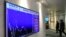 A screen displays the Hong Kong share index at the Hong Kong Stock Exchange on Oct. 4, 2021. Shares in troubled real estate developer China Evergrande Group and its property management unit Evergrande Property Services were suspended from trading Monday i