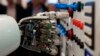 FILE - The hand of humanoid robot AILA (artificial intelligence lightweight android) operates a switchboard during a demonstration at the CeBit computer fair in Hanover, March, 5, 2013.