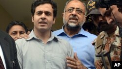 Awais Shah, center left, speaks to journalists with his father Sajjad Ali Shah, center right, chief justice of Sindh's High Court, after the son was rescued from kidnappers, in Karachi, Pakistan, Tuesday, July 19, 2016.