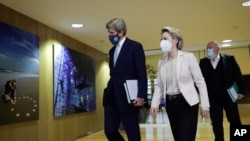 US Special Presidential Envoy for Climate John Kerry, left, European Commission President Ursula von der Leyen, center, and European Commissioner for the European Green Deal Frans Timmermans are seen prior to a meeting in Brussels, March 9, 2021.