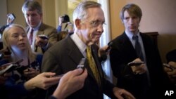 Senate Majority Leader Harry Reid, D-Nev., walks to a closed-door meeting with fellow Democrats as he and Senate Minority Leader Mitch McConnell, R-Ky., work to negotiate a legislative path to avoid the so-called "fiscal cliff," at the Capitol in Washingt