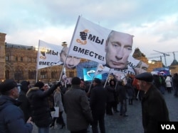 3月18日莫斯科红场的庆祝集会中，许多人手举印有普京头像的旗帜。(美国之音白桦)