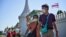 People walk with face masks outside the Grand Palace in Bangkok on January 27, 2020. - Thailand has detected eight Coronavirus cases so far -- three of whom are receiving treatment in hospital and five of whom have been discharged, according to a statemen