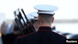 FILE - U.S. Marines prepare for the Rifle Salute during ceremonies marking the 75th anniversary of the attack on Pearl Harbor at Kilo Pier on Joint Base Pearl Harbor-Hickam in Honolulu, Hawaii, Dec. 7, 2016.