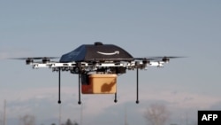 This undated handout photo released by Amazon on December 1, 2013 shows a flying "octocopter" mini-drone that would be used to fly small packages to consumers. Amazon CEO Jeff Bezos revealed on December 1 that his company was looking to the future with pl
