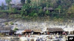  Karen villagers do their routines on the bank of the Salween river 