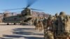 FILE - Soldiers attached to the 101st Resolute Support Sustainment Brigade, Iowa National Guard and 10th Mountain, 2-14 Infantry Battalion load onto a Chinook helicopter to head out on a mission in Afghanistan, Jan. 15, 2019.