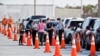 Florida Department of Health medical workers prepare to administer a COVID-19 vaccine to seniors in the parking lot of the Gulf View Square Mall in New Port Richey near Tampa, Florida, Dec. 31, 2020.