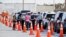 Florida Department of Health medical workers prepare to administer a COVID-19 vaccine to seniors in the parking lot of the Gulf View Square Mall in New Port Richey near Tampa, Florida, Dec. 31, 2020.