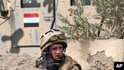 A British soldier takes position following a road side bomb which detonated as a British patrol rolled by in the southern city of Basra, Iraq (File)