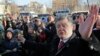 Ukraine's President Petro Poroshenko speaks with people after a wreath laying ceremony at the monument to the fallen Heroes of the "Heavenly Sotnya" (Hundred) in Kiev, Ukraine, Nov. 21, 2014.