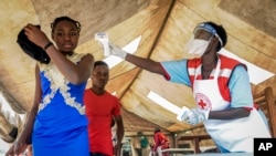 People coming from Congo have their temperature measured to screen for symptoms of Ebola, at the Mpondwe border crossing with Congo, in western Uganda, June 14, 2019.
