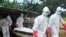 A burial team in protective gear carry the body of a woman suspected to have died from Ebola virus in Monrovia, Liberia. Oct, 18, 2014. 