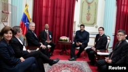 Venezuela's President Nicolas Maduro (center R) speaks to the Union of South American Nations' (UNASUR) foreign ministers at the Miraflores Palace in Caracas in this handout picture provided by the Miraflores Palace, April 7, 2014. 