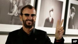 FILE - Pop icon and former Beatle Ringo Starr poses in front of some of his photographs in London, Sept. 9, 2015.