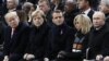 FILE - From left, President Donald Trump, German Chancellor Angela Merkel, French President Emmanuel Macron and his wife Brigitte Macron, and Russian President Vladimir Putin attend an Armistice Day ceremony in Paris, France, Nov. 11, 2018.