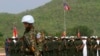 A Cambodian army soldier, foreground, wears a U.N. helmet while standing guard during a U.S.-backed peacekeeping exercise dubbed "Angkor Sentinel 2014" at the Cambodian tank command headquarters in Kampong Speu province, 60 kilometers (37 miles) west of Phnom Penh, file photo. 