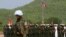 A Cambodian army soldier, foreground, wears a U.N. helmet while standing guard during a U.S.-backed peacekeeping exercise dubbed "Angkor Sentinel 2014" at the Cambodian tank command headquarters in Kampong Speu province, 60 kilometers (37 miles) west of Phnom Penh, file photo. 