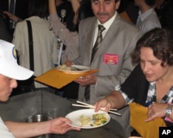 约旦驻台代表何亚礼(中)与以色列代表何玺梦尝试蚵仔煎