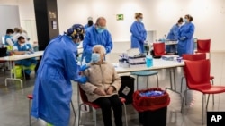 Madrid Emergency Service health workers conduct rapid antigen tests for COVID-19 in the southern neighborhood of Vallecas in Madrid, Spain, Oct. 2, 2020.