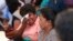 Samudra Bulathasinhala, in pink, a relative of a crew member captured by Somali pirates, cries during a meeting with Sri Lankan shipping authorities in Colombo, Sri Lanka, March 16, 2017. 