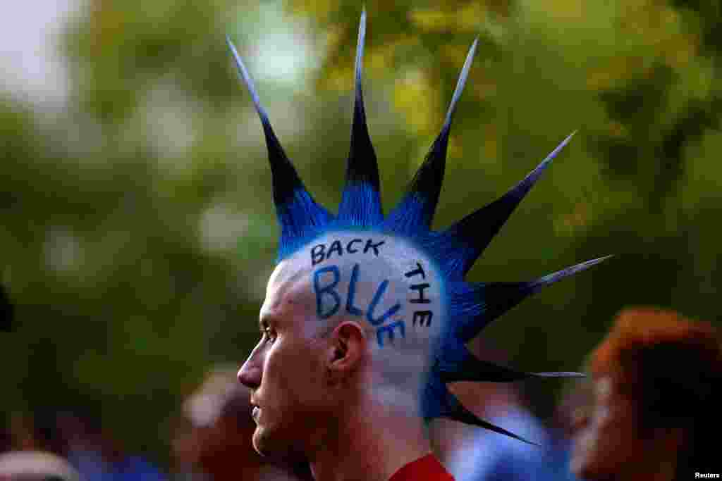 A man with a mohawk hair cut and "Back The Blue" written on his head attends a candlelight vigil at Dallas City Hall remembering the police officers killed last week, in Dallas, Texas, July 11, 2016.
